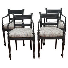 The set of four ebony carved arm chairs, shown here, are from India, circa 19th century. Featuring hand-caned seats, each chair is intricately carved of ebony wood and as stylish today as they were when they were first made. Each chair comes with newly upholstered seat cushion. Sold as set of four only. Ebony Wood, Arm Chairs, Dining Arm Chair, Dining Room Chairs, Seat Cushions, 19th Century, Upholstery, Dining Room, Carving