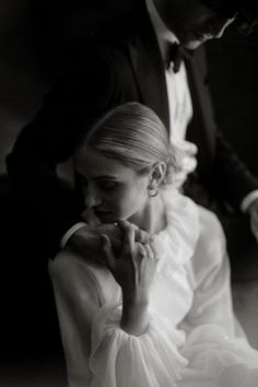 a woman in a white dress sitting next to a man