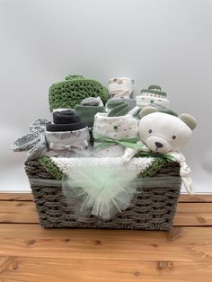 a basket filled with baby items on top of a wooden floor