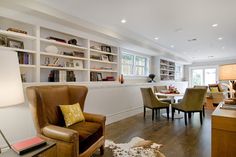 a living room filled with lots of furniture and bookshelves