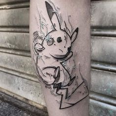 a tattoo on the leg of a man with an image of a pikachu