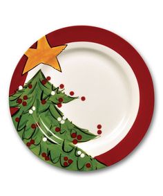 a plate with a christmas tree painted on the front and bottom, along with red trimmings