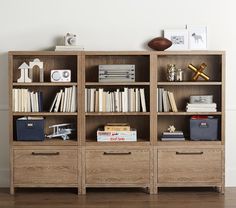 a bookshelf filled with lots of books on top of a hard wood floor