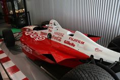 a red and white race car is on display