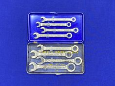 a set of wrenches in a metal case on a blue background