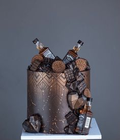 a cake decorated with liquor bottles and corks