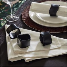 black and white place setting with napkins, wine glass, and utensils