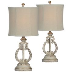 two white table lamps sitting next to each other