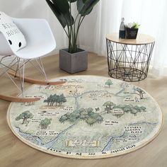 a round rug with a map on it in the middle of a room next to a chair and potted plant