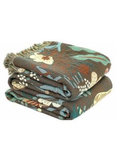 two blankets folded on top of each other with flowers and leaves printed on them,