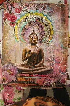 a buddha statue sitting on top of a wooden table