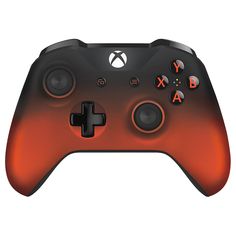 a close up of a controller on a white surface with an orange and black color scheme