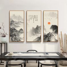 three paintings hanging on the wall above a dining room table with chairs and vases