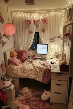 a bedroom with a bed, desk and computer