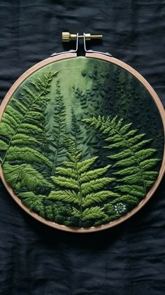 an embroidery project with green trees on it