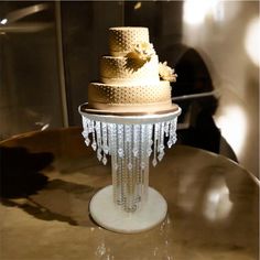 a three tiered wedding cake sitting on top of a table