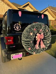 a truck with a wreath on it parked in front of a house