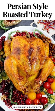 a roasted turkey on a white plate with cranberries and other holiday foods around it