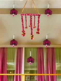 pink curtains and chandelier hanging from the ceiling