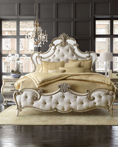 a bedroom with black walls, white furniture and a chandelier hanging from the ceiling