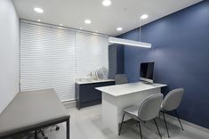 an office with blue walls and white chairs