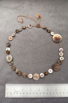 a bracelet with buttons and a measuring tape