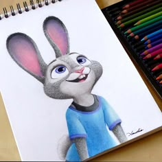 a drawing of a rabbit with colored pencils next to it