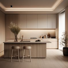 a kitchen with two stools and a center island in front of the countertop