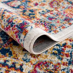 an area rug with multicolored flowers on it