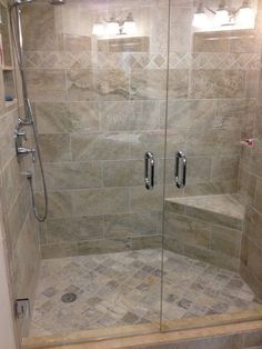 a walk in shower sitting inside of a bathroom