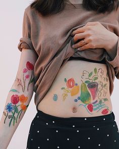 a woman with flowers painted on her stomach