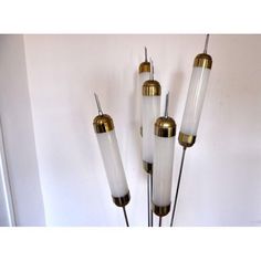 three brass and glass lamps hanging on the wall