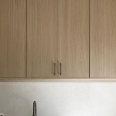 a kitchen with wooden cabinets and stainless steel sink faucet next to it's dishwasher