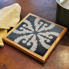 a black and white tile is on the floor next to a potted yellow cloth