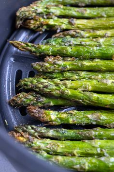 asparagus in an air fryer ready to be cooked