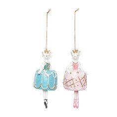 two ornaments are hanging from chains on white background, one is pink and the other is blue