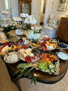 a table filled with lots of food on top of a hard wood floored floor