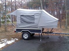 a trailer with a tent attached to it