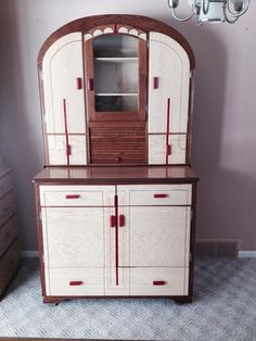 a white and brown china cabinet in a room