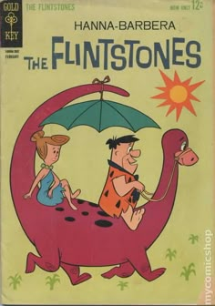 the flintstones comic book cover with an image of two children riding on a dinosaur