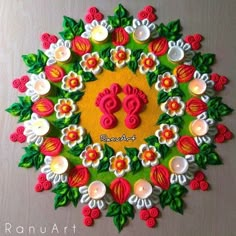 a colorful rang art design with candles and flowers