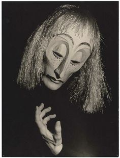 a black and white photo of a person wearing a mask