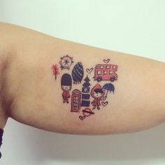 a small tattoo on the arm of a girl with various things in it's heart