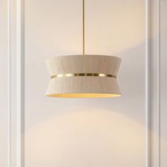 a light fixture hanging from the ceiling in a room with white walls and flooring