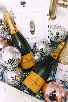 several bottles of champagne and disco balls on a table