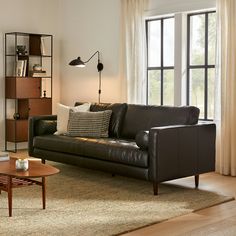 a living room filled with furniture and windows