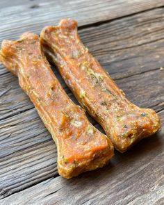 two pieces of raw dog food sitting on top of a wooden table