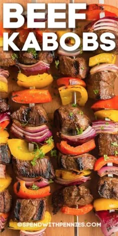 beef kabobs on skewers with peppers, onions and carrots in them