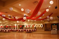 an empty ballroom with red and white decorations