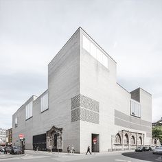 a large white building sitting on the side of a road